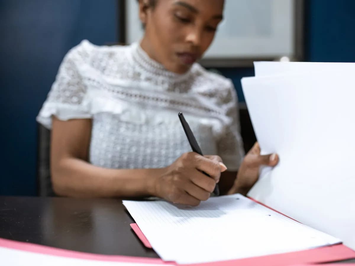 Two people signing an insurance policy document